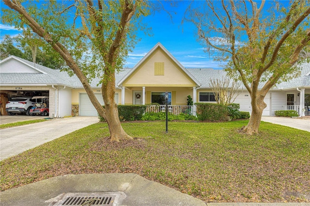 view of front of house with a front yard, covered porch, and a garage