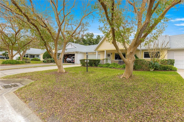 view of front of house with a front lawn, a garage, and covered porch