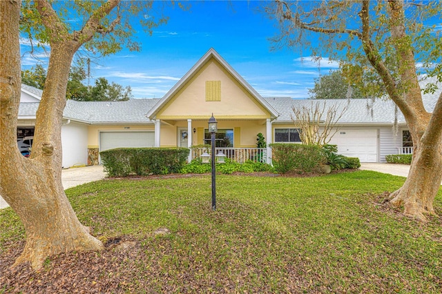 ranch-style house featuring covered porch, a garage, and a front lawn