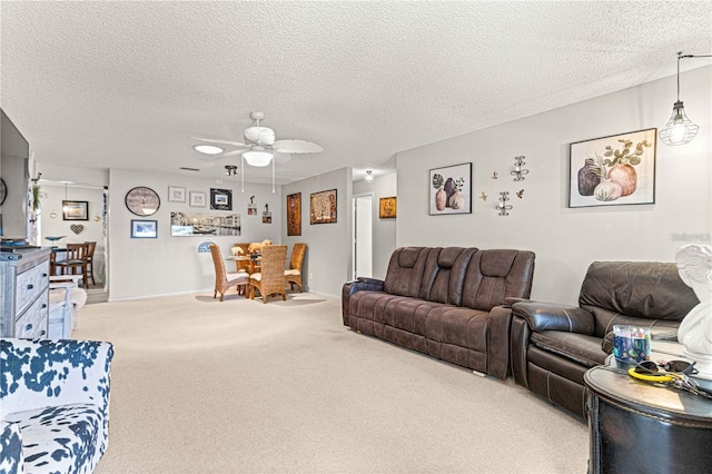 carpeted living room featuring a textured ceiling and ceiling fan