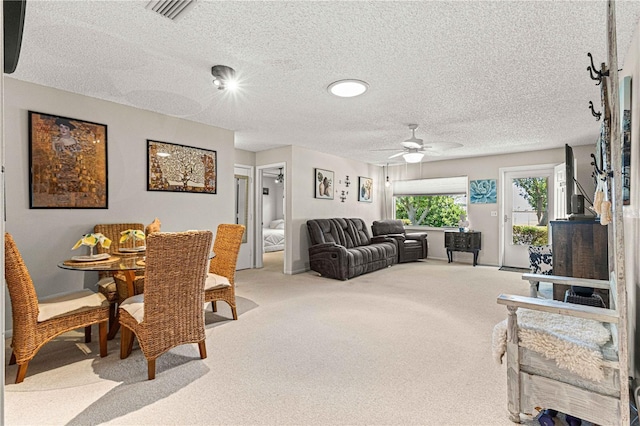 carpeted dining room featuring ceiling fan