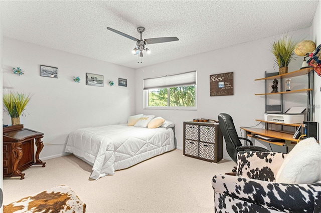 bedroom featuring ceiling fan, a textured ceiling, and light carpet