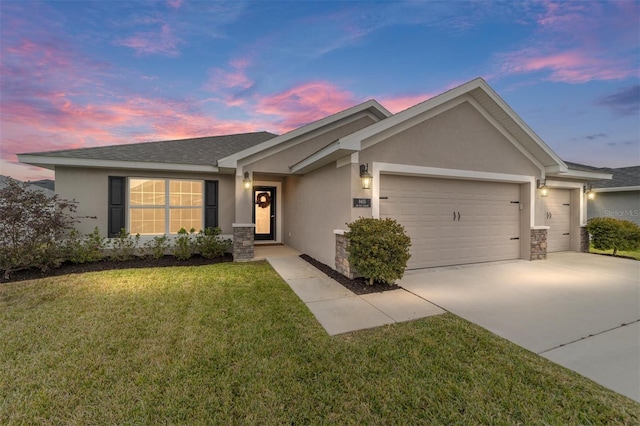 view of front of house featuring a garage and a lawn