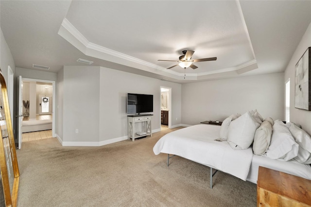 carpeted bedroom with a raised ceiling, connected bathroom, ceiling fan, and crown molding