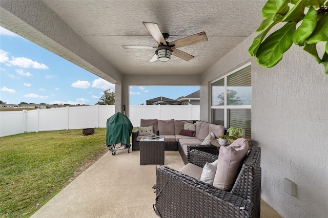 view of patio featuring grilling area, ceiling fan, and outdoor lounge area