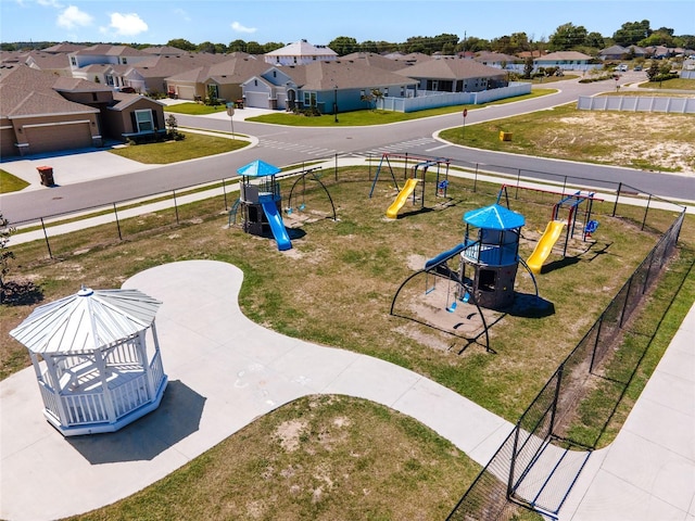 exterior space featuring a gazebo, a playground, and a lawn