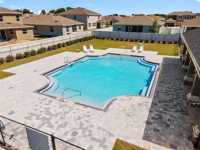 view of pool featuring a yard and a patio