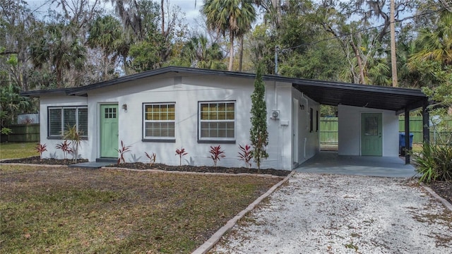 view of front of property with a front yard and a carport