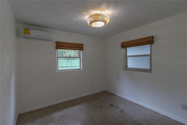 spare room featuring an AC wall unit