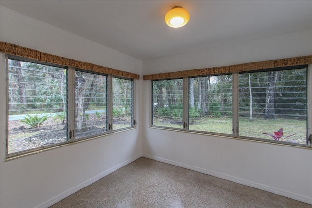 unfurnished sunroom featuring a wealth of natural light