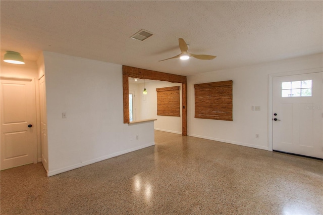 spare room featuring a textured ceiling and ceiling fan