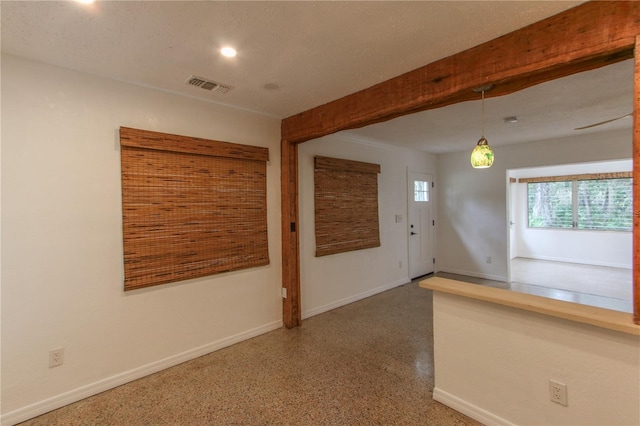 unfurnished room with a textured ceiling