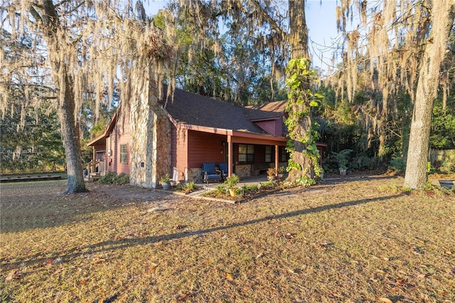 exterior space featuring a lawn and a patio area