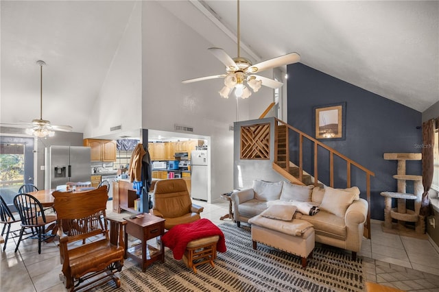 tiled living room with high vaulted ceiling and ceiling fan