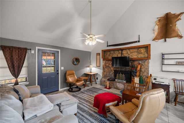 living room featuring lofted ceiling, a fireplace, ceiling fan, and light tile patterned floors