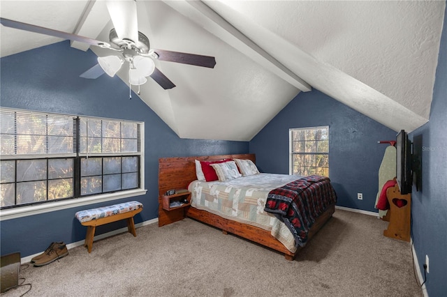 carpeted bedroom with ceiling fan and vaulted ceiling