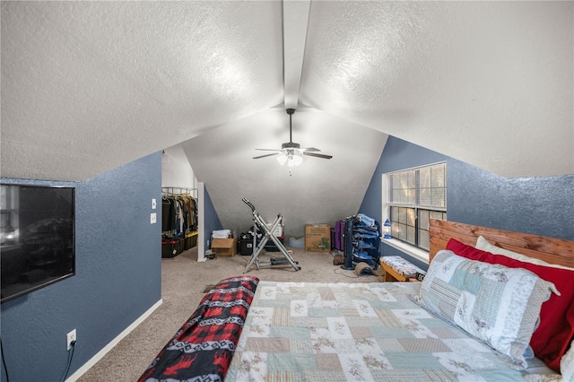 unfurnished bedroom with a textured ceiling, ceiling fan, vaulted ceiling, and light colored carpet