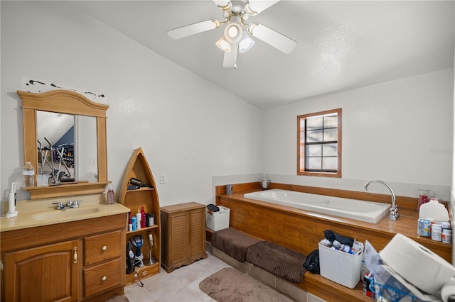 bathroom featuring ceiling fan, a tub to relax in, tile patterned flooring, and vanity