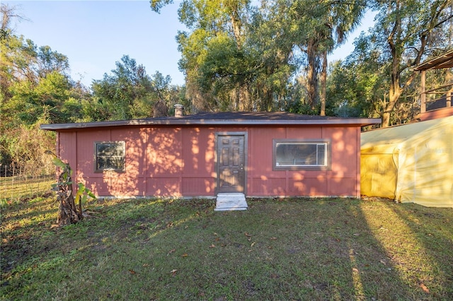 view of outbuilding featuring a yard