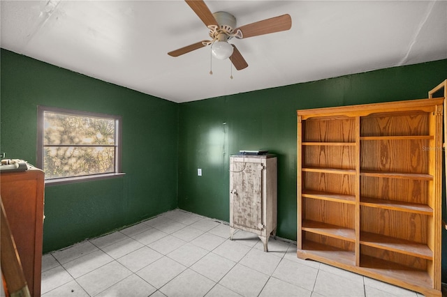 unfurnished bedroom with ceiling fan and light tile patterned floors