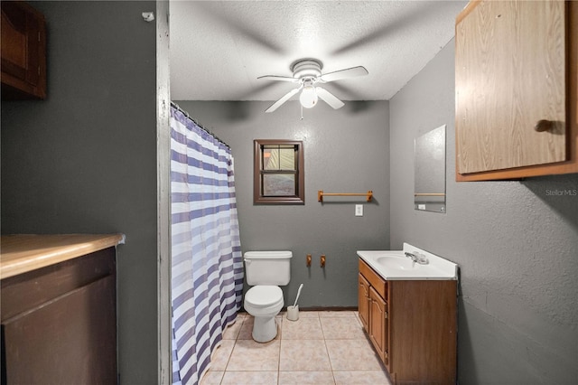 bathroom with toilet, a textured ceiling, tile patterned flooring, ceiling fan, and vanity