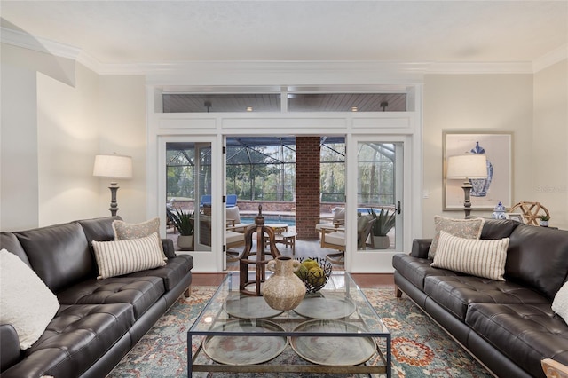 living room featuring hardwood / wood-style flooring, a healthy amount of sunlight, and ornamental molding