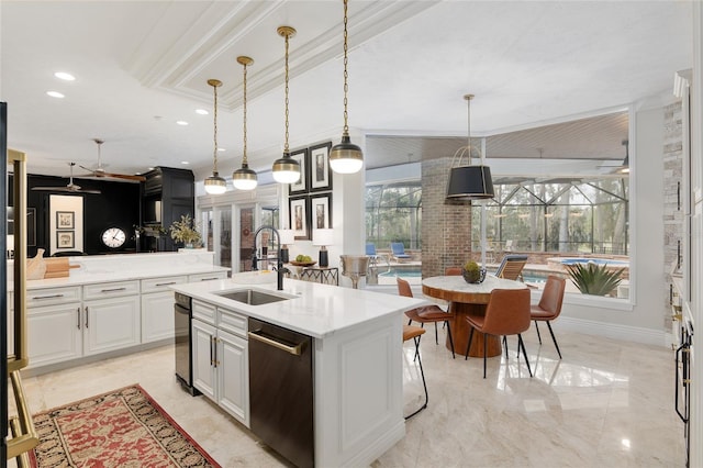 kitchen with pendant lighting, sink, dishwasher, white cabinetry, and an island with sink