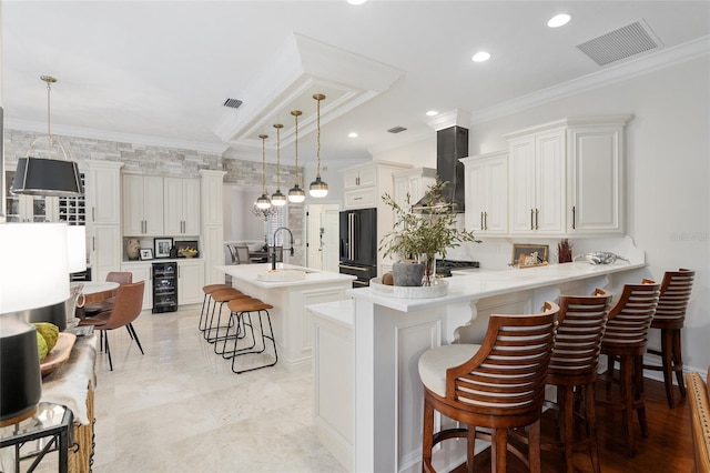 kitchen with a breakfast bar, kitchen peninsula, high quality fridge, and decorative light fixtures