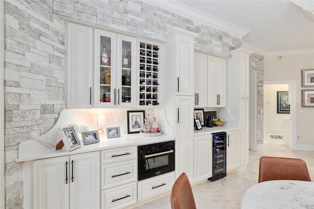 bar featuring wine cooler, white cabinetry, crown molding, and oven