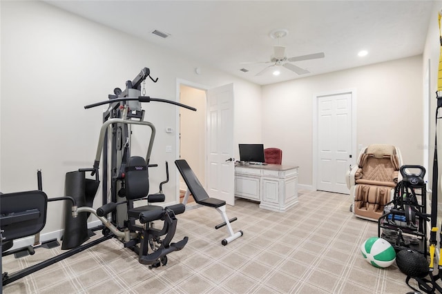 exercise room featuring ceiling fan and light carpet