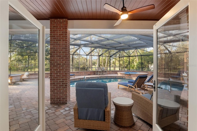 view of patio with a swimming pool with hot tub, a lanai, and pool water feature