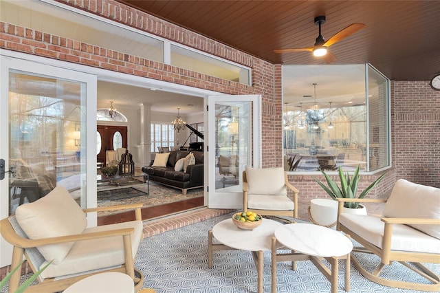 sunroom with wood ceiling and ceiling fan with notable chandelier