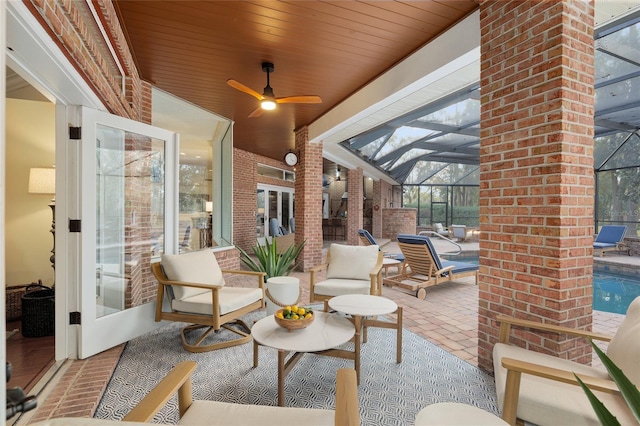 view of patio / terrace featuring glass enclosure, ceiling fan, and french doors