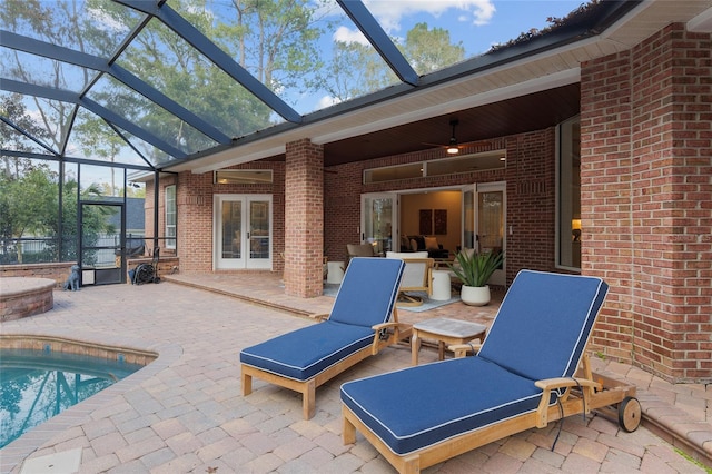 view of patio featuring a lanai, french doors, and ceiling fan