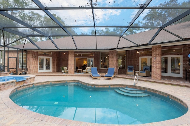 view of swimming pool featuring a lanai, a patio, ceiling fan, and an in ground hot tub