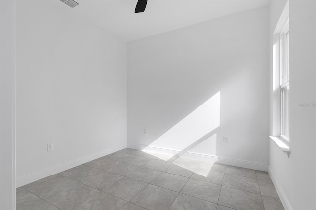 unfurnished room with ceiling fan and light tile patterned flooring