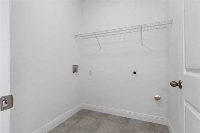 laundry room featuring electric dryer hookup, hookup for a washing machine, and tile patterned floors