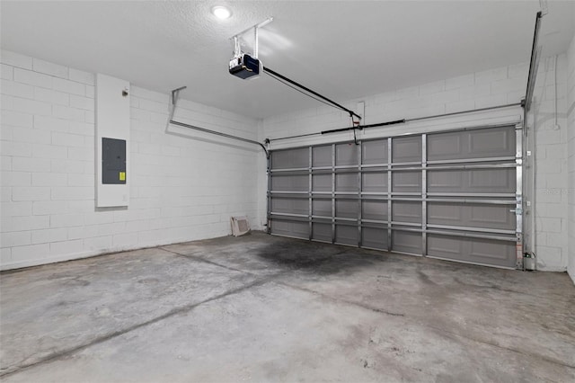 garage with electric panel and a garage door opener