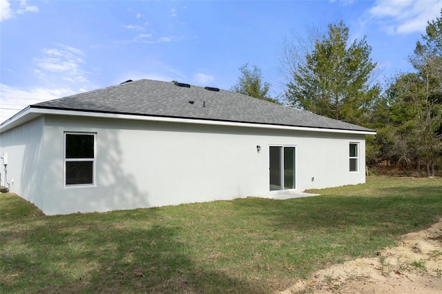 back of house featuring a yard