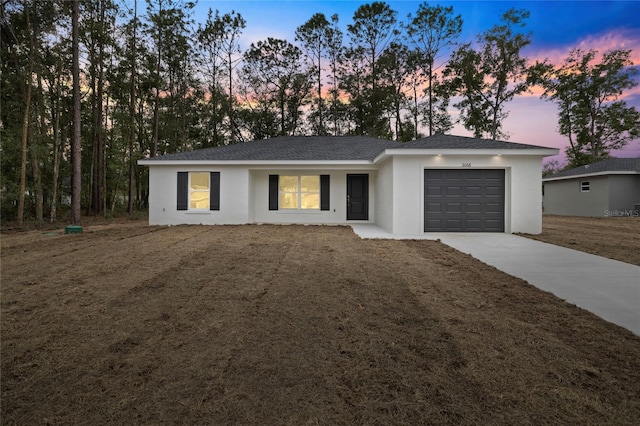 ranch-style house featuring a lawn and a garage