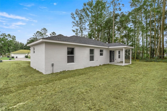 back of house with a yard and a patio area