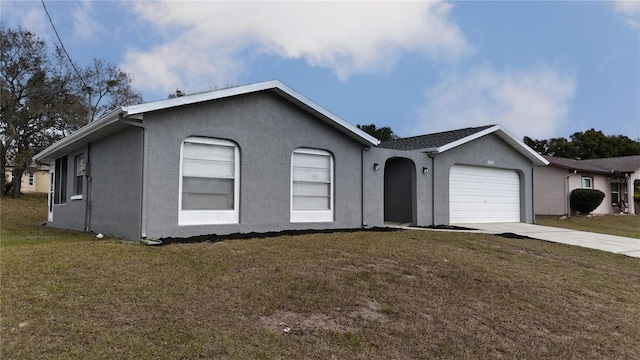 ranch-style house featuring a front yard and a garage