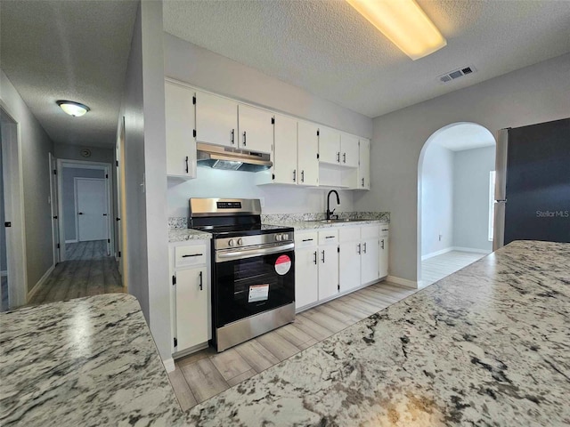 kitchen with sink, white cabinets, and appliances with stainless steel finishes