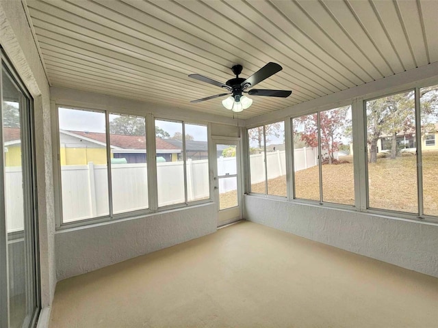 unfurnished sunroom with wooden ceiling and ceiling fan