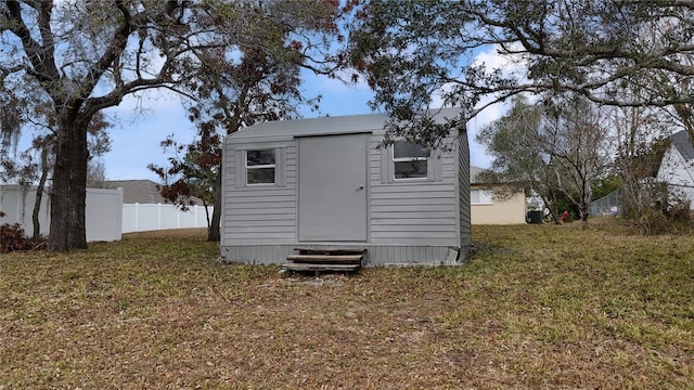 view of outbuilding with a lawn