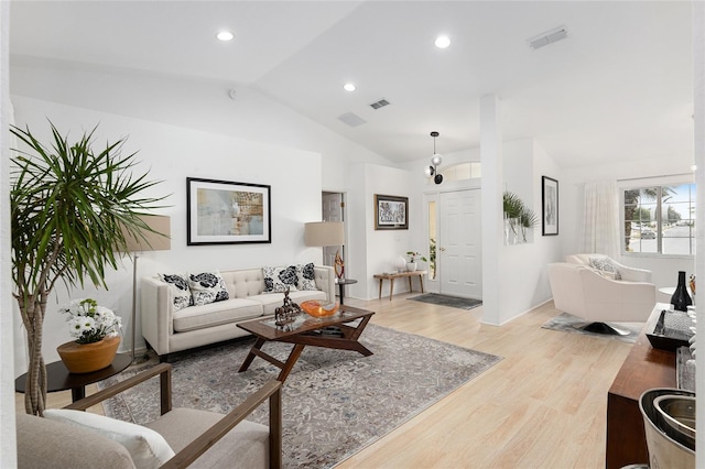 living room featuring light hardwood / wood-style flooring and lofted ceiling