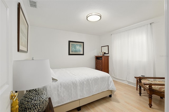 bedroom with hardwood / wood-style flooring