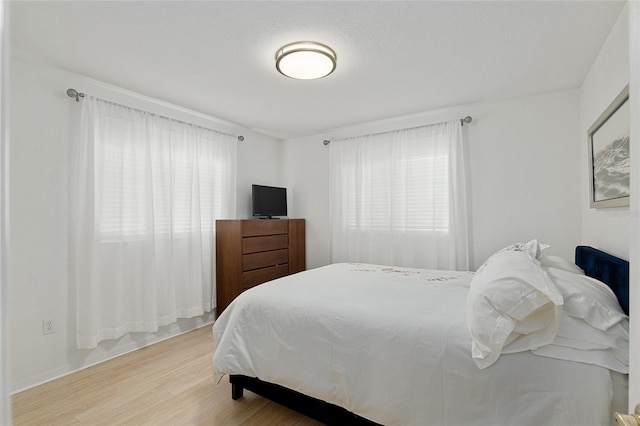 bedroom with hardwood / wood-style flooring