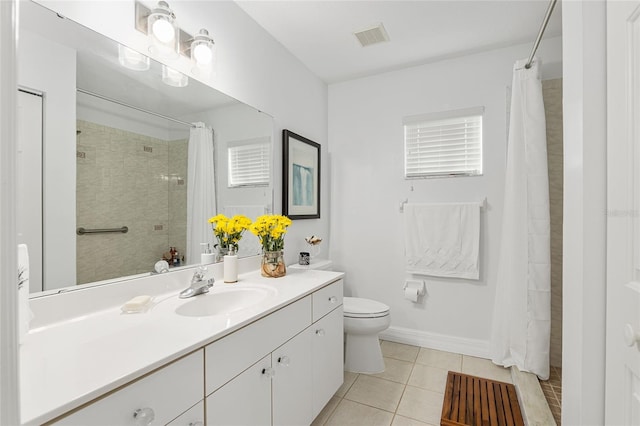 bathroom with toilet, vanity, tile patterned floors, and curtained shower