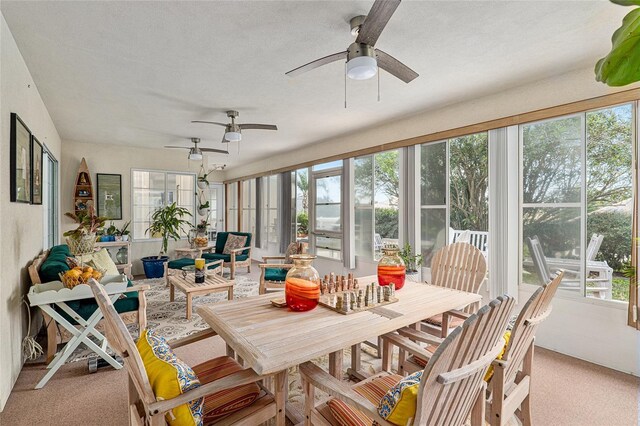 sunroom with a healthy amount of sunlight and ceiling fan